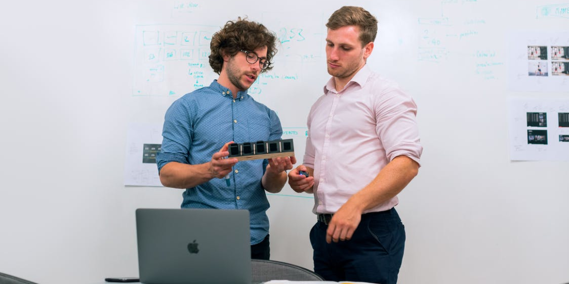 Two engineers discussing a mechanical product